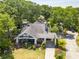 Inviting home features lush landscaping, mature trees, and a welcoming front porch perfect for relaxing at 1000 Nw Main St, Conyers, GA 30012