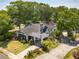 Aerial view of a charming home with a well-manicured lawn, mature trees, and inviting front porch at 1000 Nw Main St, Conyers, GA 30012
