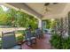 Relaxing front porch with ceiling fan, rocking chairs, stained glass accents, and beautiful plants at 1000 Nw Main St, Conyers, GA 30012