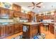 Charming kitchen featuring wood cabinetry, granite countertops, an island, and stainless steel appliances at 1000 Nw Main St, Conyers, GA 30012