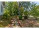 Charming stone pathway winds through the verdant landscape, offering a serene and picturesque outdoor experience at 1000 Nw Main St, Conyers, GA 30012