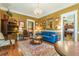 Warm living room with hardwood floors, blue sofa, and chandelier lighting at 1000 Nw Main St, Conyers, GA 30012