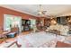 Inviting living room featuring hardwood floors, large windows, a ceiling fan and elegant furnishings at 1000 Nw Main St, Conyers, GA 30012
