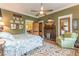 Bedroom features hardwood floors, a ceiling fan, a fireplace, and lots of natural light at 1000 Nw Main St, Conyers, GA 30012