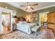 Bedroom boasts hardwood floors, a ceiling fan, and two entry doors on either side of the bed at 1000 Nw Main St, Conyers, GA 30012
