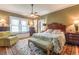 Cozy bedroom features a sitting area, hardwood floors, large windows, and a ceiling fan at 1000 Nw Main St, Conyers, GA 30012