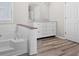 Bright bathroom featuring a soaking tub, vinyl floors, and a dual sink vanity at 108 Kelly Ct, Dallas, GA 30157