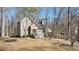 Exterior view of a quaint home with mature trees offering shade and privacy on a sunny day at 108 Kelly Ct, Dallas, GA 30157