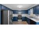 Kitchen featuring navy cabinets, stainless steel appliances, and ample counter space for food preparation and entertaining at 108 Kelly Ct, Dallas, GA 30157
