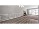 Open-concept living room featuring hardwood floors and a cozy stone fireplace at 108 Kelly Ct, Dallas, GA 30157