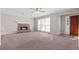 Bright living room featuring a stone fireplace and a view of the front entryway and a large window at 108 Kelly Ct, Dallas, GA 30157