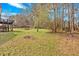 Expansive backyard with mature trees and lush greenery that is perfect for outdoor activities at 127 Hyde Way, Dallas, GA 30157