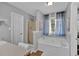 Bathroom featuring a soaking tub, separate shower, and natural light from a window at 127 Hyde Way, Dallas, GA 30157