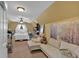 Comfortable bedroom featuring a seating area, playpen, and ample natural light at 127 Hyde Way, Dallas, GA 30157