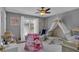 Charming bedroom with a play tent, white furniture, and floral accents at 127 Hyde Way, Dallas, GA 30157