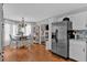 Open kitchen and dining area with stainless steel appliances, wood floors, white cabinets and updated finishes at 127 Hyde Way, Dallas, GA 30157