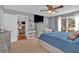 Spacious main bedroom with a large bed, ceiling fan, neutral walls, and backyard views at 127 Hyde Way, Dallas, GA 30157