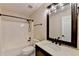 Neutral bathroom with vanity sink, tub and shower combination, and a large framed mirror at 2697 Links Overlook Drive Dr, Dacula, GA 30019