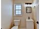 Cozy bathroom offers bright lighting, single sink vanity, and matching black hardware at 2697 Links Overlook Drive Dr, Dacula, GA 30019