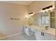 Elegant bathroom featuring dual sinks, bright lighting, and sleek fixtures, glass shower and tub nearby at 2697 Links Overlook Drive Dr, Dacula, GA 30019