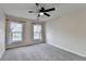 Spacious bedroom featuring neutral paint, soft carpet, a fan, and two windows with natural lighting at 2697 Links Overlook Drive Dr, Dacula, GA 30019