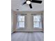 The bedroom features plush gray carpeting, and two windows that provide plenty of natural light at 2697 Links Overlook Drive Dr, Dacula, GA 30019