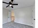 Neutral bedroom with ceiling fan, carpet, and natural light; an adjacent hallway is visible at 2697 Links Overlook Drive Dr, Dacula, GA 30019