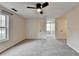 Spacious bedroom featuring plush carpeting, neutral paint, and two windows with natural light at 2697 Links Overlook Drive Dr, Dacula, GA 30019