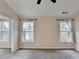 Spacious bedroom featuring neutral paint, soft carpet, and two windows with natural lighting at 2697 Links Overlook Drive Dr, Dacula, GA 30019