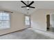 Spacious bedroom featuring neutral paint, soft carpet, vaulted ceiling and a fan at 2697 Links Overlook Drive Dr, Dacula, GA 30019