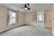 Large bedroom with gray carpet, a ceiling fan, and two windows allowing for lots of natural light at 2697 Links Overlook Drive Dr, Dacula, GA 30019