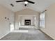 Spacious bedroom featuring neutral paint, soft carpet, fireplace, and two windows with natural lighting at 2697 Links Overlook Drive Dr, Dacula, GA 30019