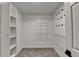 Walk-in closet with built-in shelving and racks for organized storage at 2697 Links Overlook Drive Dr, Dacula, GA 30019