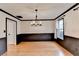 Dining room displays dark wainscoting, bright windows, and hardwood flooring at 2697 Links Overlook Drive Dr, Dacula, GA 30019