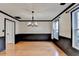An elegant dining room with wainscotting and a modern chandelier at 2697 Links Overlook Drive Dr, Dacula, GA 30019