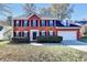 Charming two-story brick home with manicured landscaping and an attached two-car garage at 2697 Links Overlook Drive Dr, Dacula, GA 30019