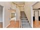 Inviting foyer with hardwood floors, staircase, and views into other living spaces at 2697 Links Overlook Drive Dr, Dacula, GA 30019