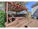 The wood pergola covers the hot tub with built in benches and surrounding deck at 2697 Links Overlook Drive Dr, Dacula, GA 30019