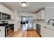 Modern kitchen features white cabinets, quartz countertops, and stainless steel appliances at 2697 Links Overlook Drive Dr, Dacula, GA 30019