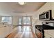 Open concept kitchen with stainless appliances and access to outdoor deck at 2697 Links Overlook Drive Dr, Dacula, GA 30019