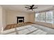 Bright living room with a fireplace, ceiling fan, and large window at 2697 Links Overlook Drive Dr, Dacula, GA 30019
