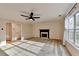 Carpeted living room with a ceiling fan and a charming fireplace at 2697 Links Overlook Drive Dr, Dacula, GA 30019