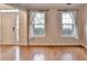Welcoming living room shows hardwood floors, bright windows, and neutral walls at 2697 Links Overlook Drive Dr, Dacula, GA 30019