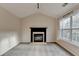 Living room boasts a fireplace, plush carpet, neutral paint, and a large window at 2697 Links Overlook Drive Dr, Dacula, GA 30019
