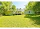 Spacious backyard featuring a detached garage and a home with a deck at 5115 Cascade Palmetto Hwy, Fairburn, GA 30213
