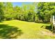 Expansive and well-maintained backyard with lush green grass and mature trees at 5115 Cascade Palmetto Hwy, Fairburn, GA 30213
