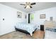 Bright bedroom featuring a bed with patterned linens, wood floors and a ceiling fan at 5115 Cascade Palmetto Hwy, Fairburn, GA 30213