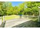 Exterior deck with white railing overlooking a large wooded backyard at 5115 Cascade Palmetto Hwy, Fairburn, GA 30213