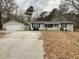 Charming single story home with detached garage, large front yard, and inviting front porch at 5115 Cascade Palmetto Hwy, Fairburn, GA 30213