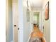 Bright hallway with wood floors leading to bedrooms and bathroom at 5115 Cascade Palmetto Hwy, Fairburn, GA 30213